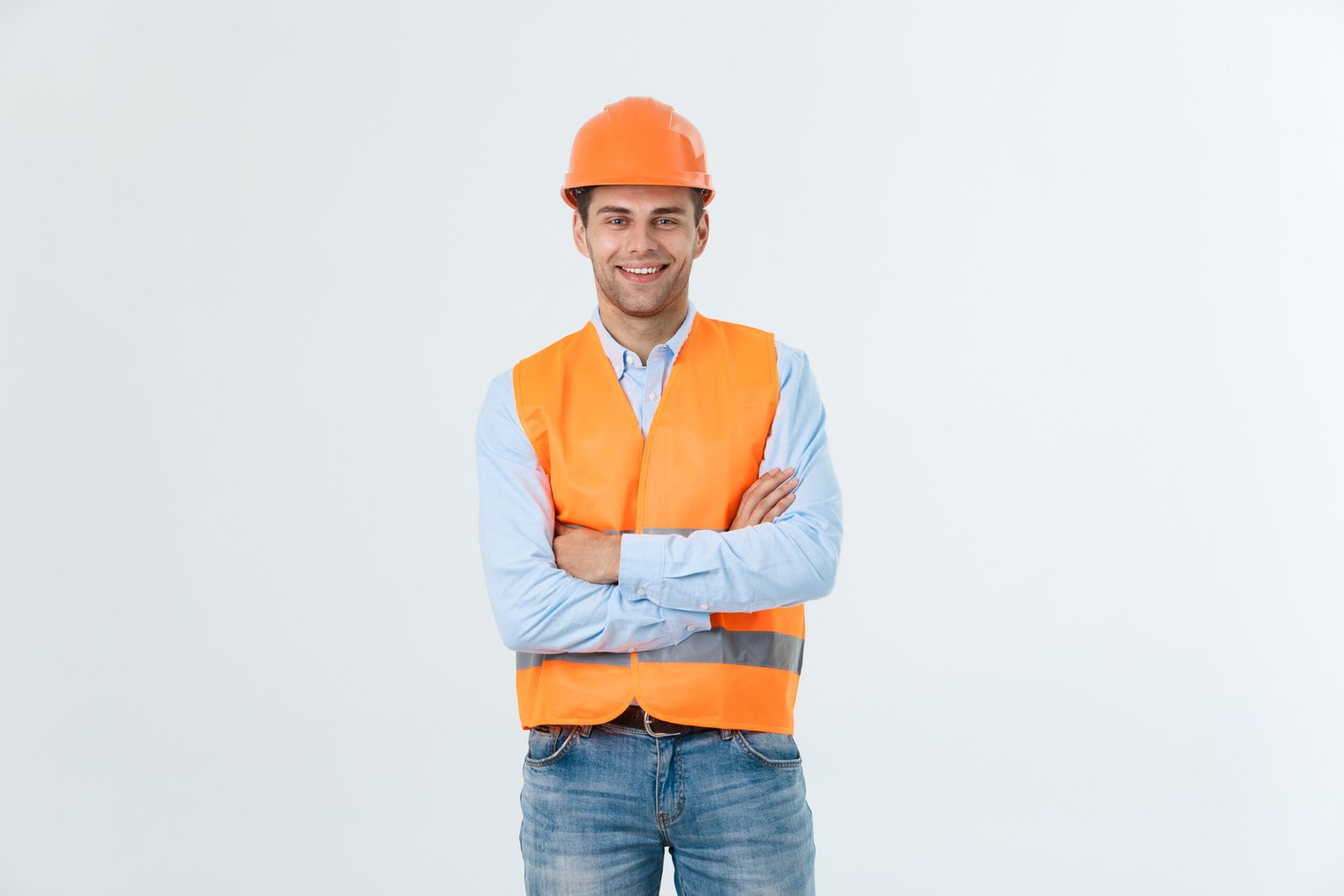 Smiling construction engineer posing with arms crossed Image description